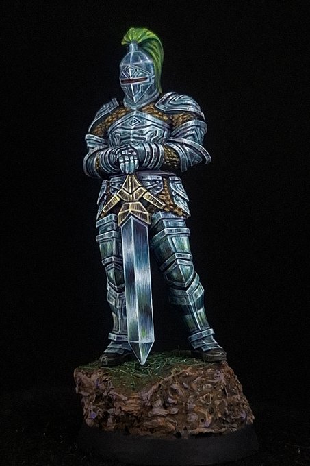 A knight in full non-metallic metal armour, front on. The plate runs from near-black in the shadows to near-white glints on every upward-facing edge in a few millimetres, the chainmail and belt plate are painted gold with a brown-to-cream ramp, and the sword blade carries a single gradient down its length. There is no metallic pigment anywhere on the model.